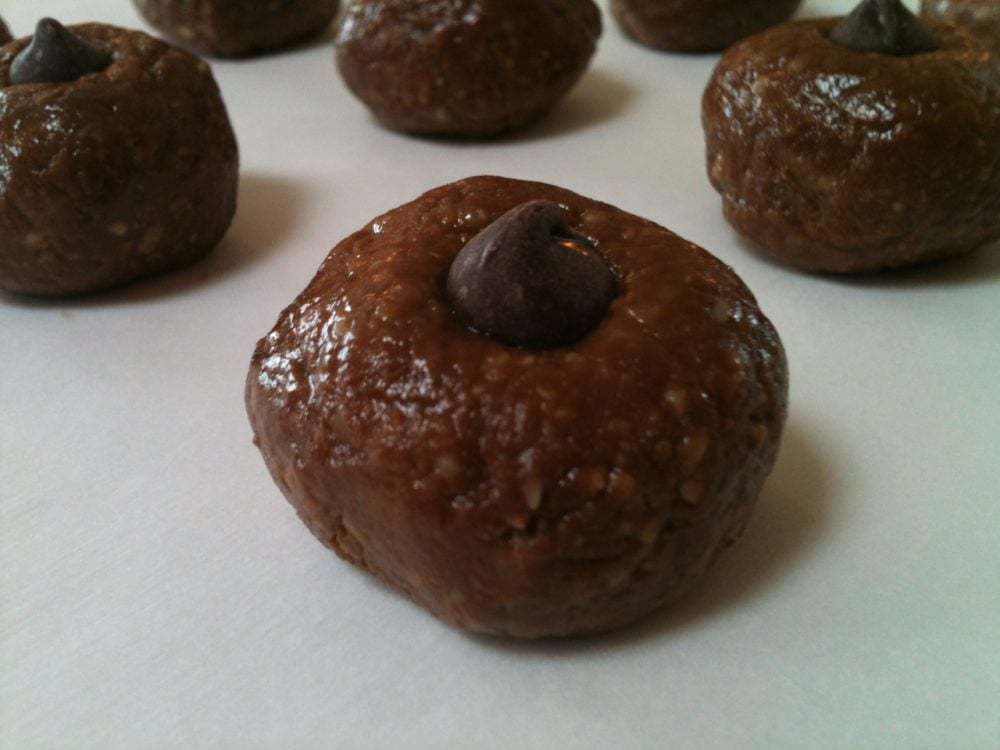 A group of chocolate balls on a white surface.