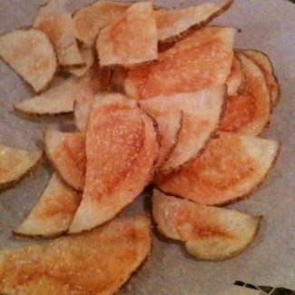 Baked potato chips on a baking sheet.