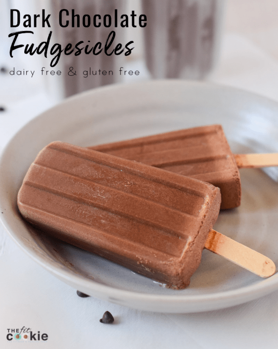 two creamy dairy free chocolate fudgesicles on a white plate
