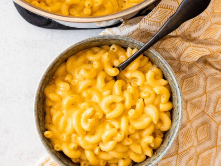 Mac and cheese served in a bowl with a spoon.