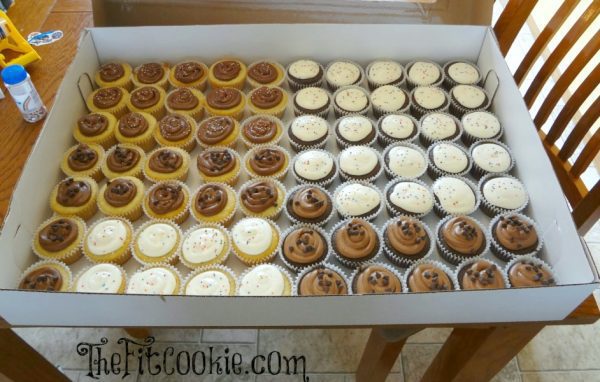 large box of vegan vanilla cupcakes and vegan chocolate cupcakes with frosting and sprinkles