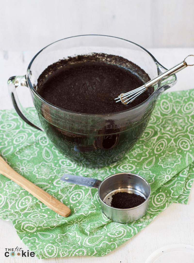 glass pitcher bowl filled with water and coffee grounds for making cold brew coffee