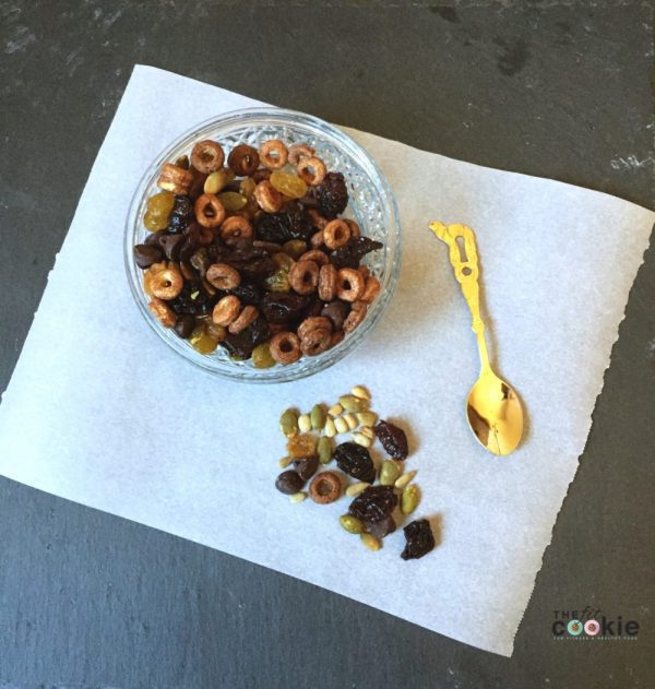 nut free trail mix in a glass bowl with cheerios
