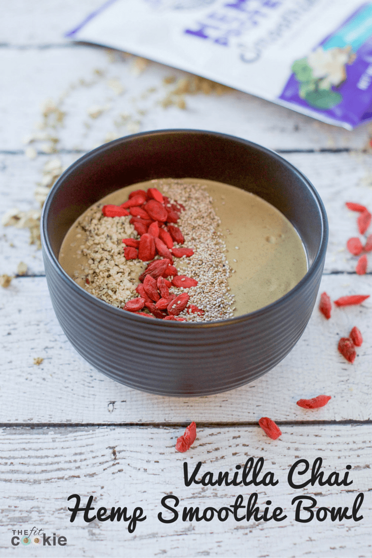 black bowl filled with vegan vanilla chai hemp protein smoothie topped with goji berries and hemp seeds