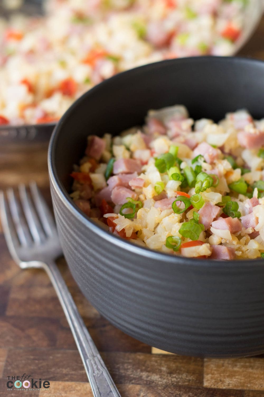 This Simple Pork Fried Cauliflower Rice is a quick, one-pot dinner that can be made in under 30 minutes and it's very affordable - less than $2.50 per serving. Plus it's free of grains, gluten, soy, eggs, and peanuts! - @TheFitCookie #fitfluential #thereciperedux #paleo