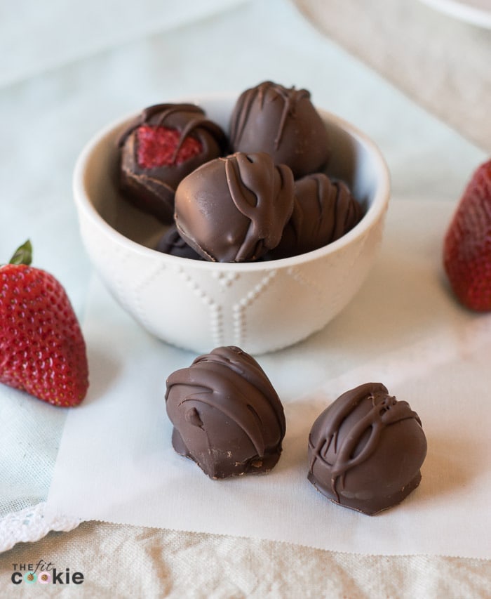 These Strawberry Coconut Truffles have the perfect ratio of chocolate and strawberry filling, and they make a beautiful homemade gift. The filling is made with simple and allergy-friendly ingredients so they are gluten-free and vegan, and fit many special diets. But everyone can enjoy these treats even if they don't have food allergies! - TheFitCookie.com