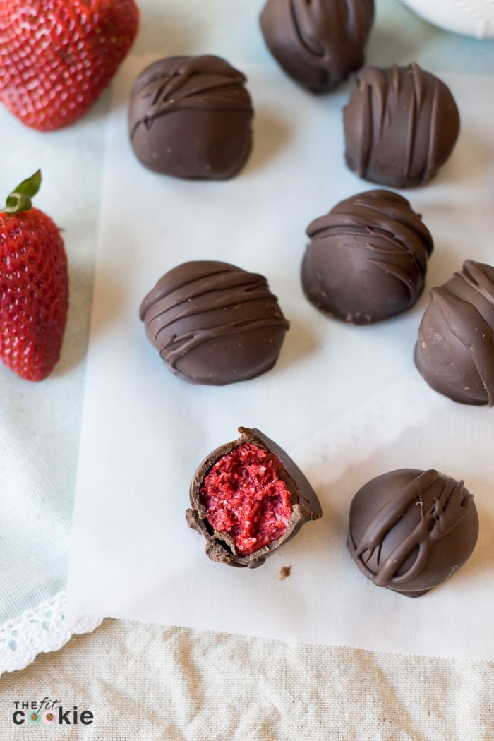 These Strawberry Coconut Truffles have the perfect ratio of chocolate and strawberry filling, and they make a beautiful homemade gift. The filling is made with simple and allergy-friendly ingredients so they are gluten-free and vegan, and fit many special diets. But everyone can enjoy these treats even if they don't have food allergies! - TheFitCookie.com