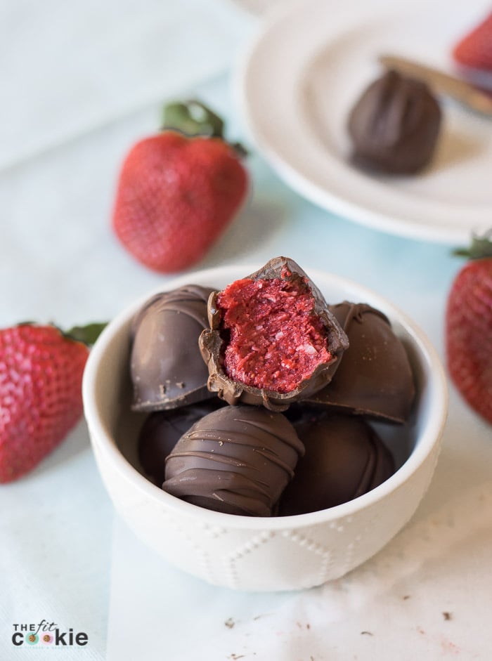 These Strawberry Coconut Truffles have the perfect ratio of chocolate and strawberry filling, and they make a beautiful homemade gift. The filling is made with simple and allergy-friendly ingredients so they are gluten-free and vegan, and fit many special diets. But everyone can enjoy these treats even if they don't have food allergies! - TheFitCookie.com