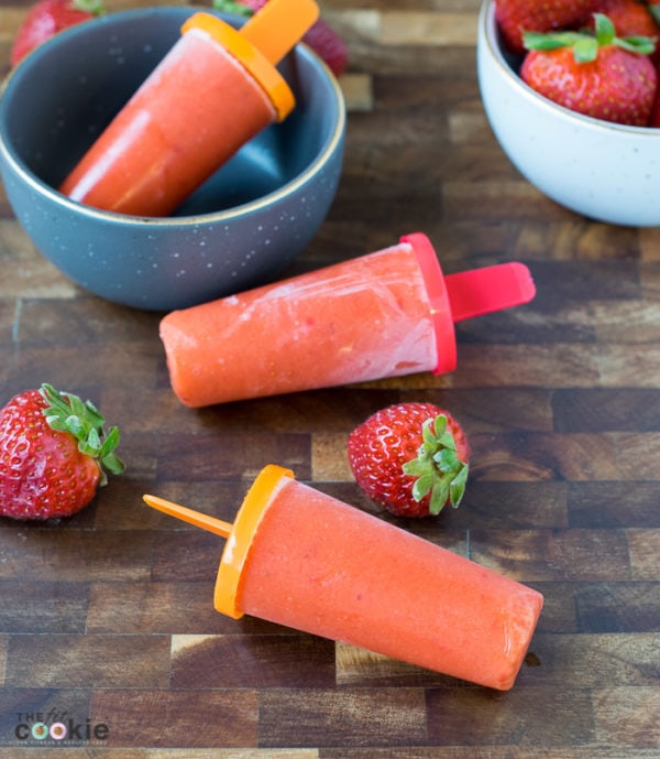 If you're looking for some healthy cool treats for summer, make these Strawberry Mango Popsicles - they only have 3 ingredients! Plus they are paleo and vegan, too - TheFitCookie.com