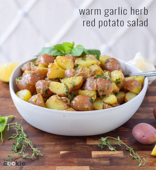 Make a healthier potato salad that's great any time of year! This Warm Garlic Herb Red Potato Salad is perfect as an allergy friendly side dish for any occasion, and looks impressive as a dinner party side dish. This recipe has no mayo and is also grain free, gluten free, dairy free, egg free, and vegan. - #AD #Potatoes @TheFitCookie #glutenfree #nomayo #vegan #CLVR 