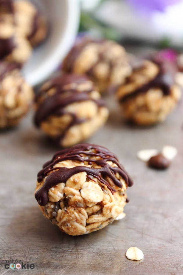 close up photo of a oat and chia snack bite drizzled with chocolate. 