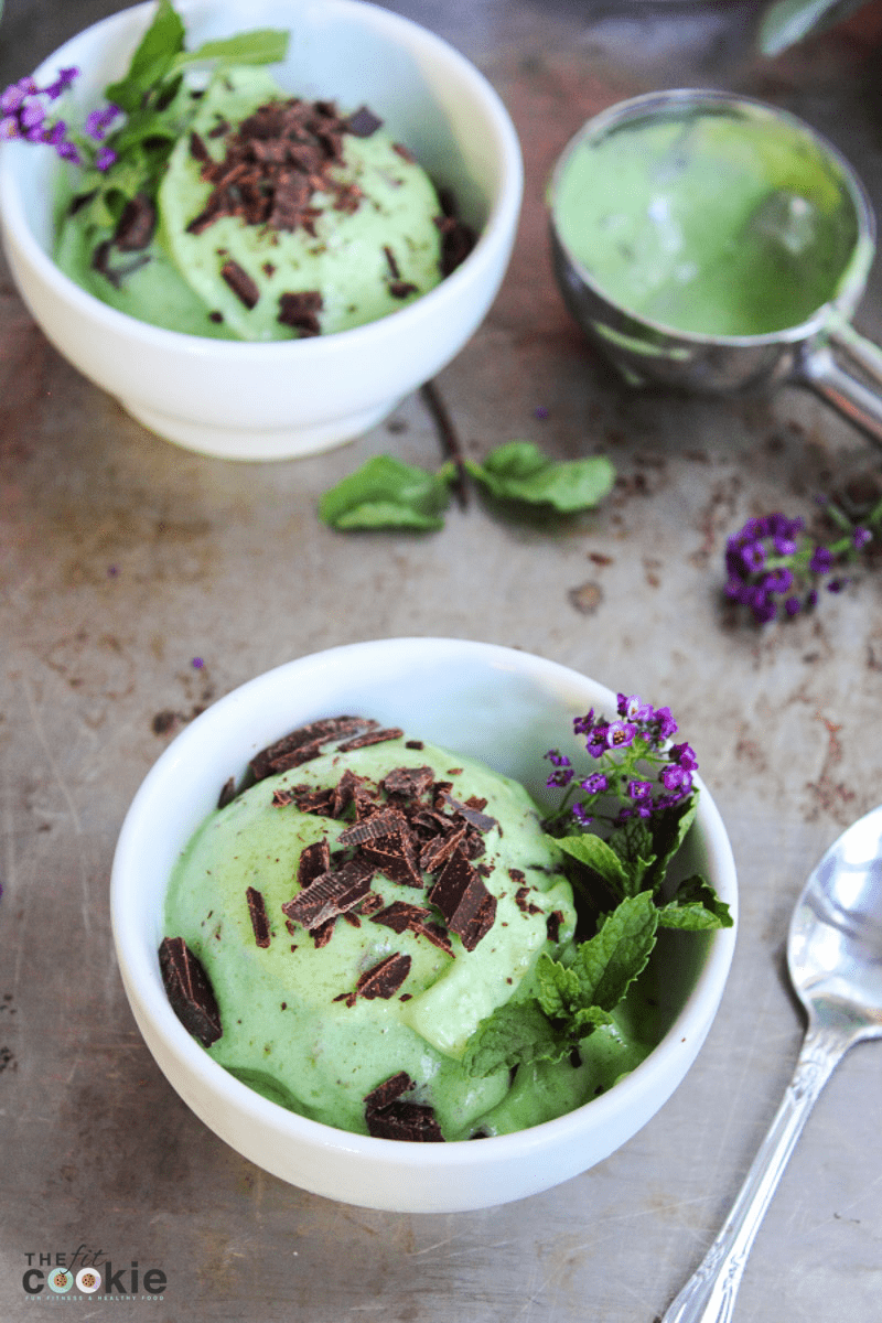 mint ice cream in a white bowl with chocolate on top