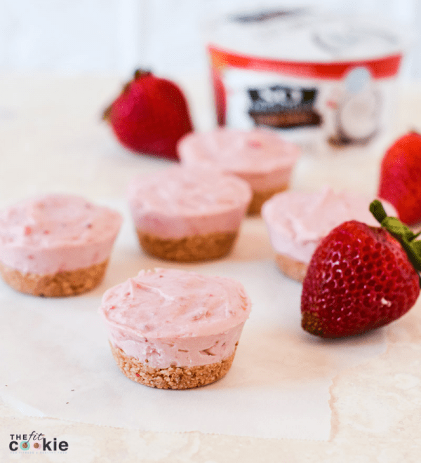 gluten free vegan mini strawberry cheesecakes next to strawberries