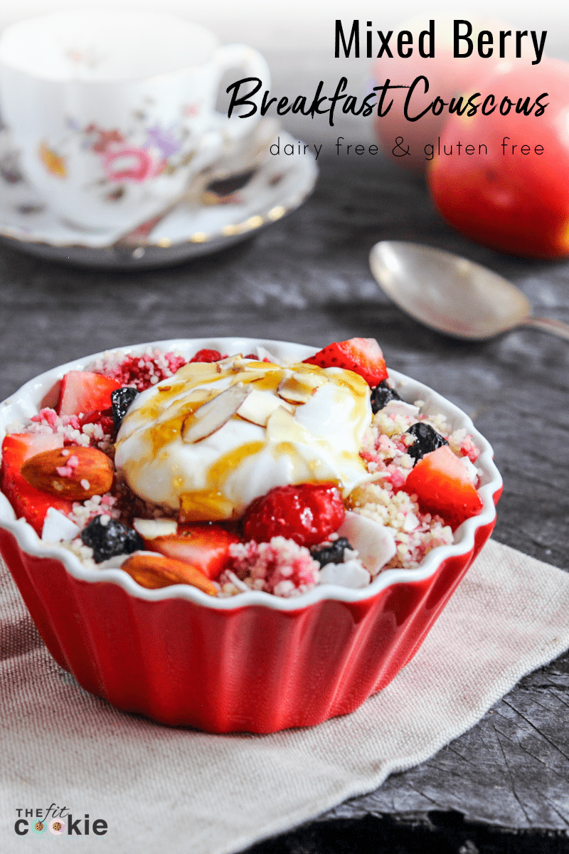 red dish filled with mixed berry breakfast couscous.