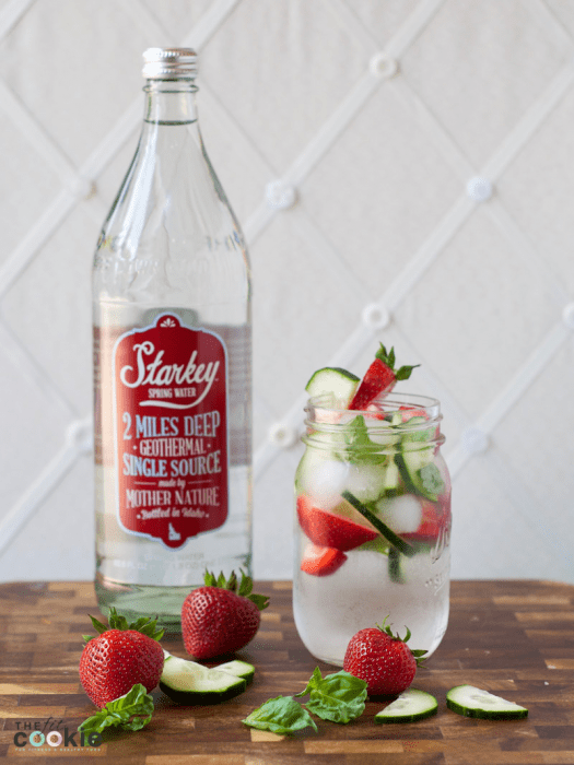 jar of fruit infused water next to a glass bottle of Starkey water