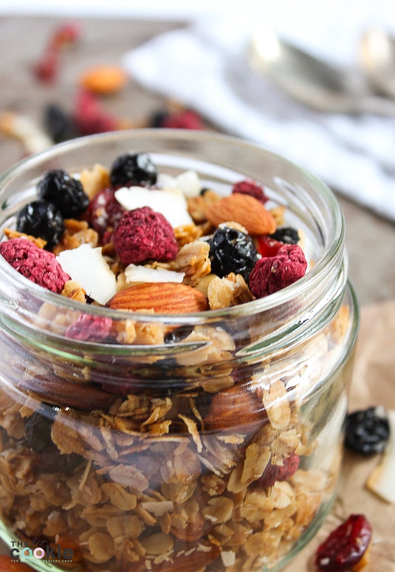 close up photo of gluten free granola with berries in a jar