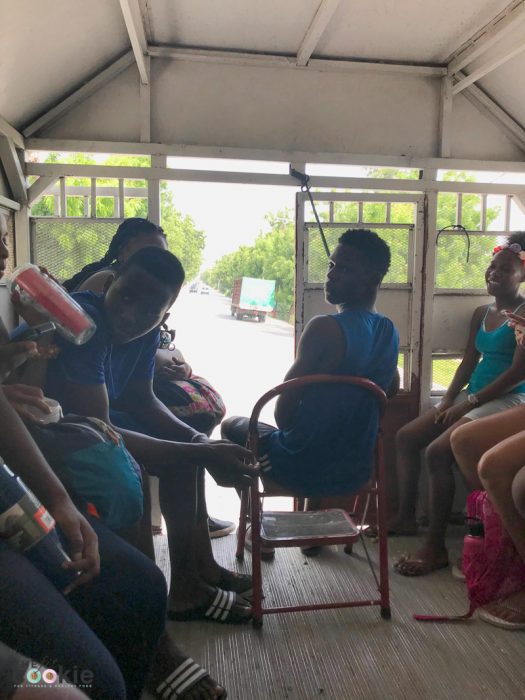 group of people in the tap tap driving on a road in Cabaret, Haiti