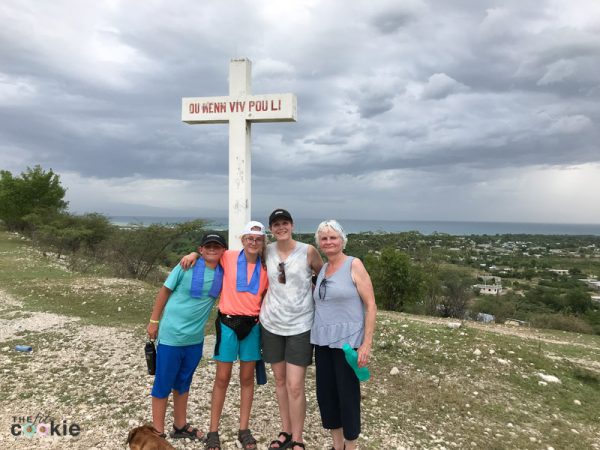 family on top of the hill in front of a cross overlooking Bercy and Cabaret Haiti