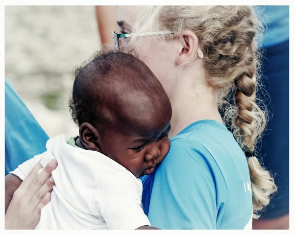 photo of my daughter holding a Haitian baby
