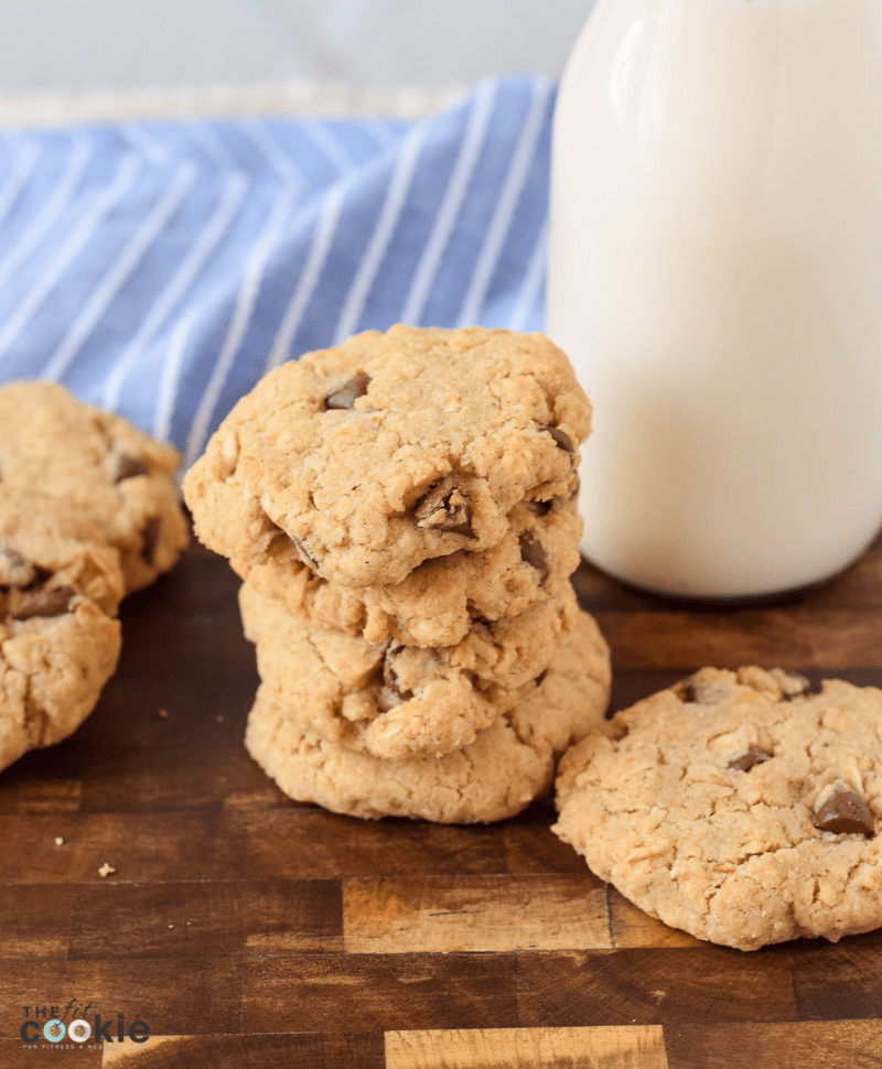 photo of stacked gluten free oatmeal cookies on a wood cutting board. 
