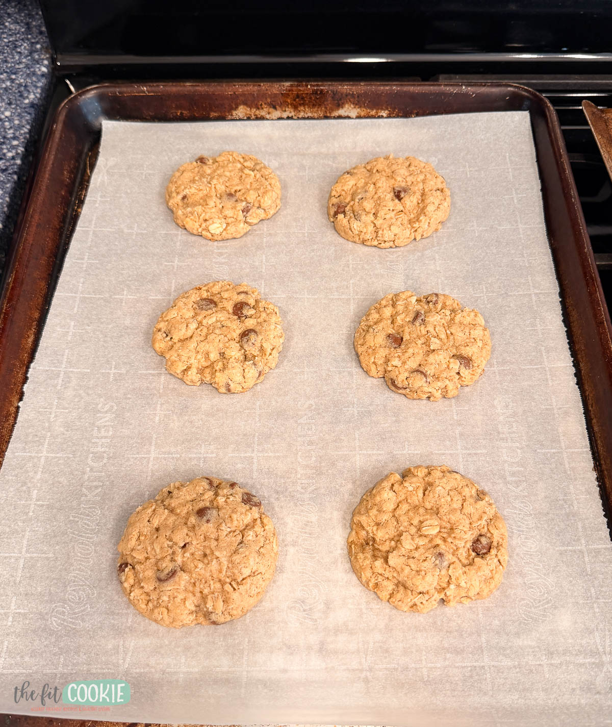 6 oatmeal cookies that have been lightly shaped and are a more uniform circle. 