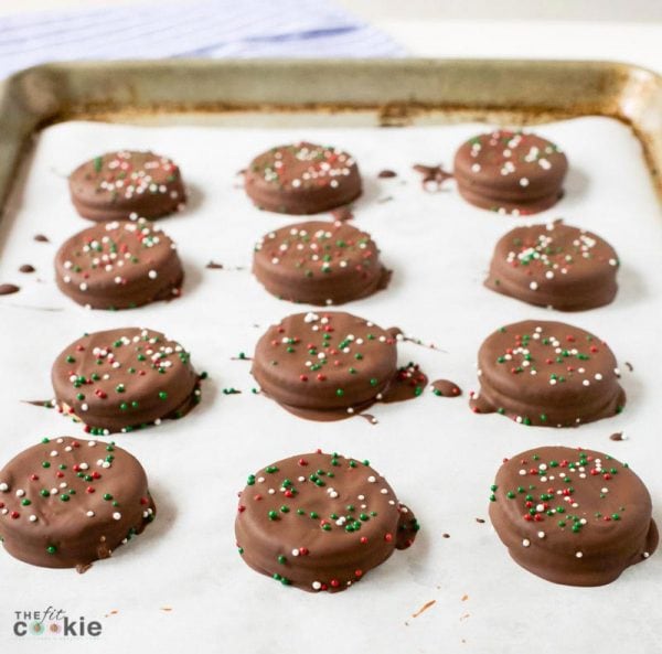 sheet pan of dairy free chocolate ritz cracker cookies topped with Christmas sprinkles