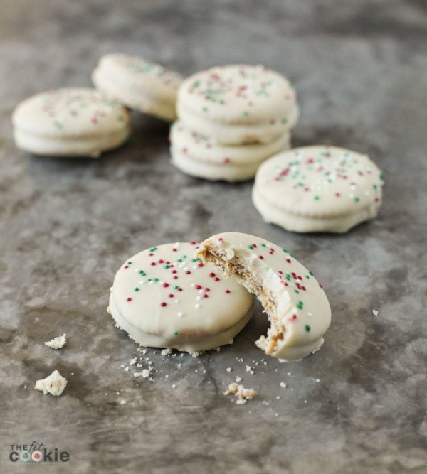 dairy free white chocolate ritz cracker cookies stacked with a bite taken from one cookie