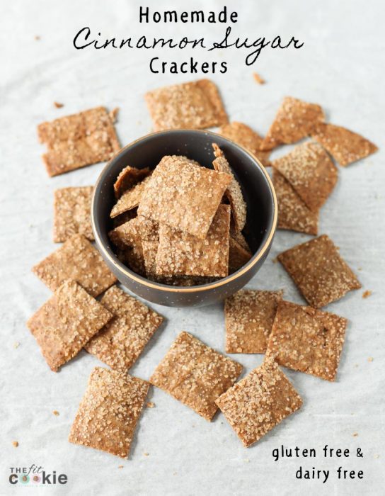 overhead photo of dairy free gluten free cinnamon sugar crackers in a gray bowl and on parchment paper