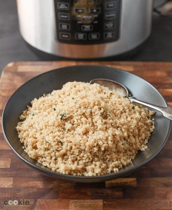 bowl of cilantro lime quinoa in front of an instant pot pressure cooker