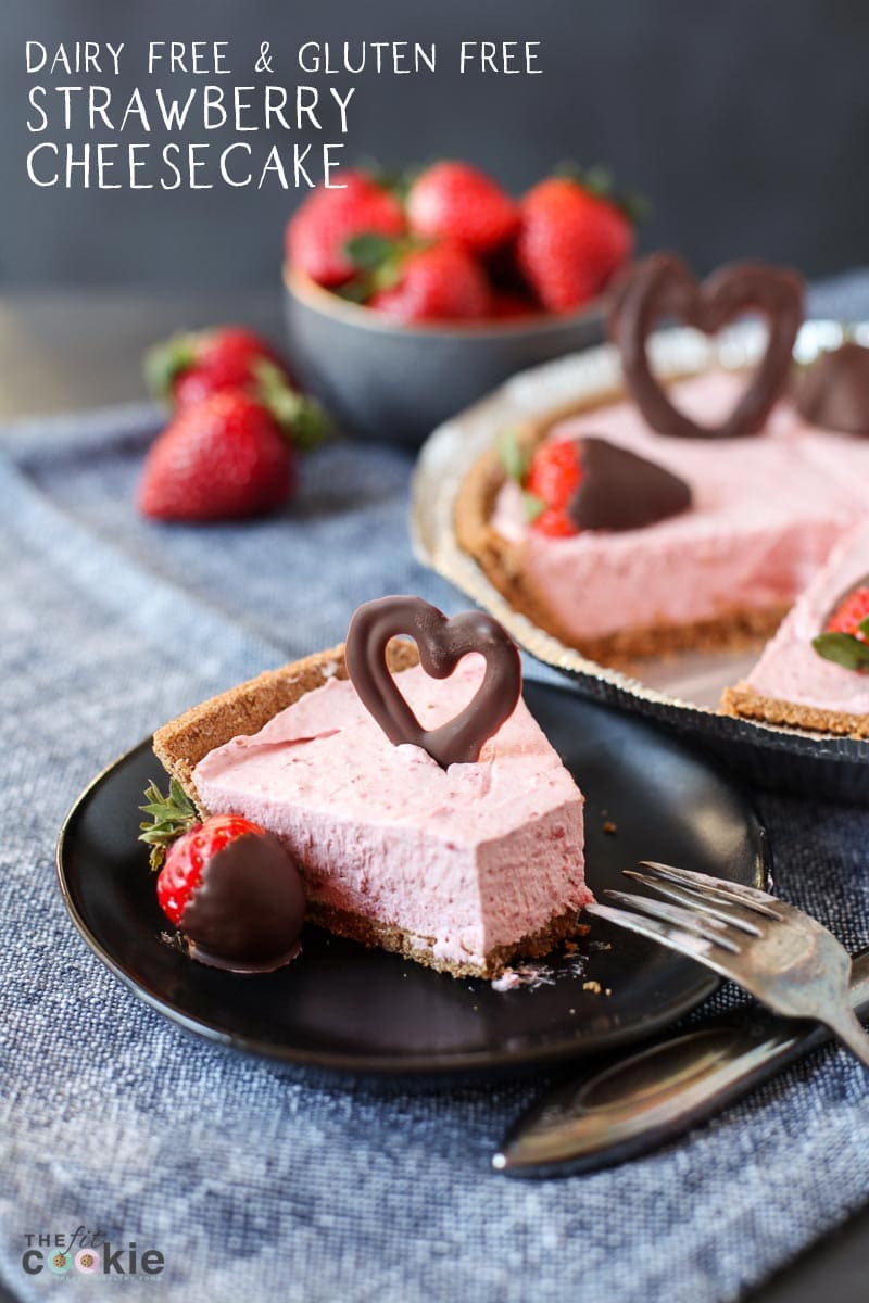 slice of dairy free strawberry cheesecake on black plate with text overlay