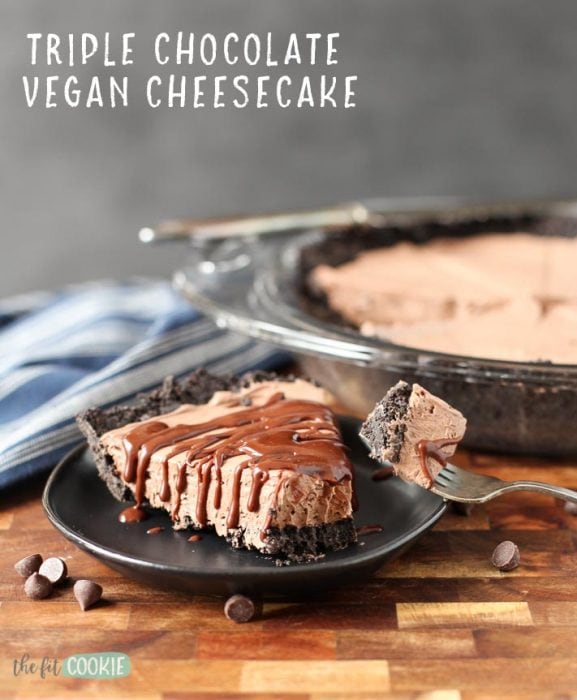 slice of dairy free chocolate cheesecake on a black plate with a bite taken