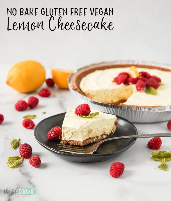 vegan lemon cheesecake slice on a black plate topped with raspberries