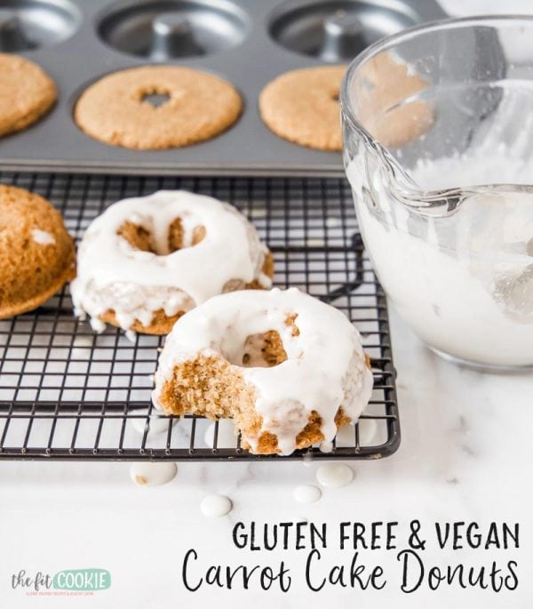 vegan gluten free carrot cake donuts with glaze on a black wire cooling rack