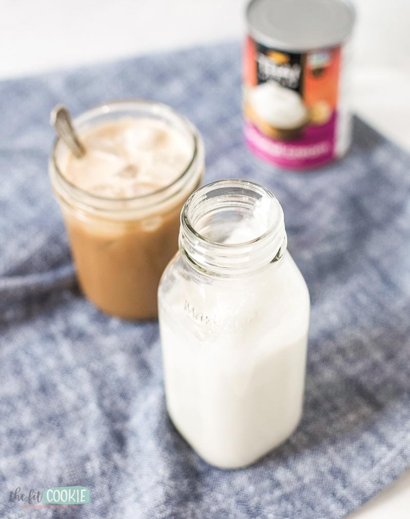 glass bottle of keto coffee creamer next to a glass of coffee.