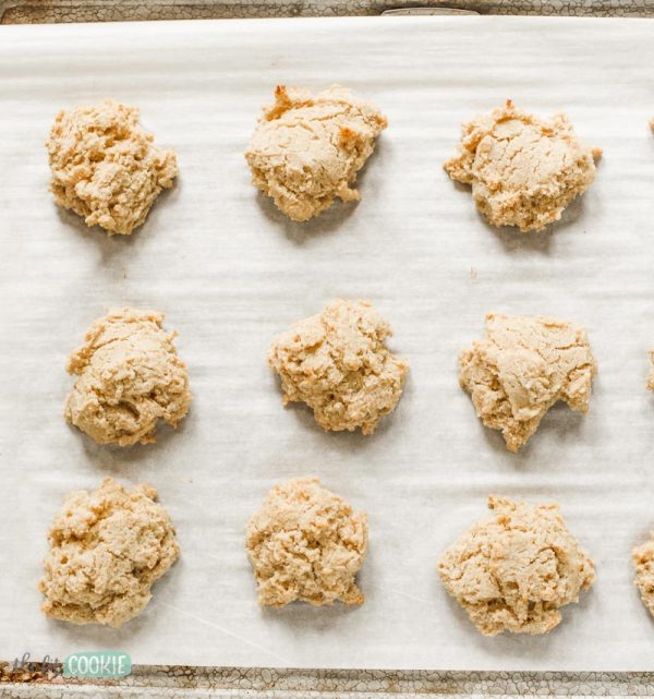 overhead photo of dairy free drop biscuits on a baking sheet lined with parchment paper