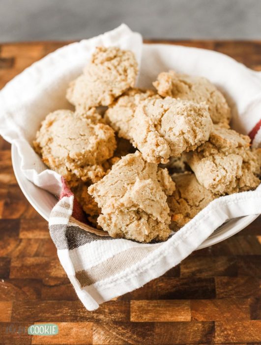 photo of vegan drop biscuits in a bowl lined with a white cloth