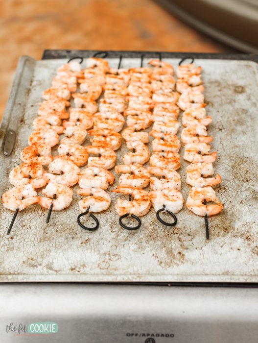 photo of easy chili lime grilled shrimp on skewers on a baking sheet pan 