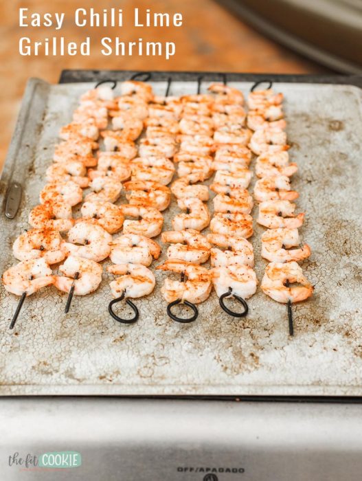 photo of grilled shrimp on skewers on a baking sheet pan with text overlay