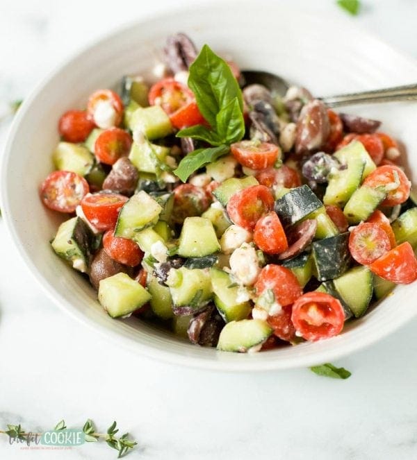close up photo of dairy free greek salad in a white dish