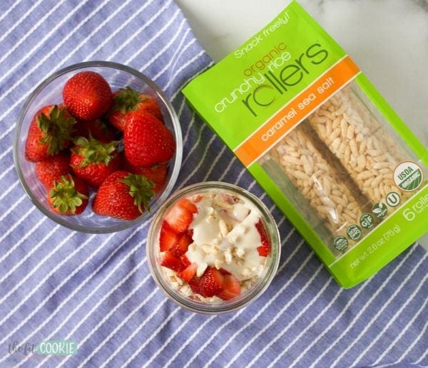 overhead photo of vegan yogurt parfait in a jar next to strawberries