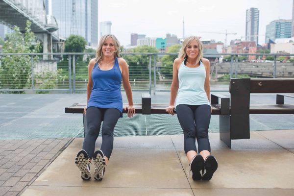 2 women doing dips off a bench outside - hotel room workout