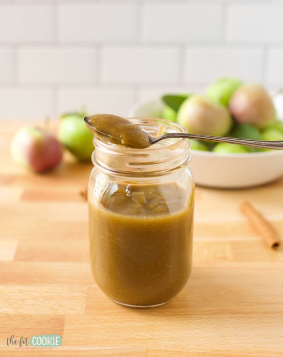 jar of instant pot apple butter with a spoon on top