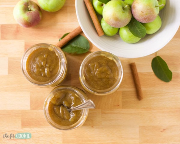 overhead photo of pressure cooker apple butter next to a bowl of apples