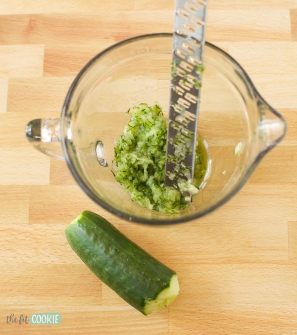 grating cucumber for tzatziki on a coarse microplane