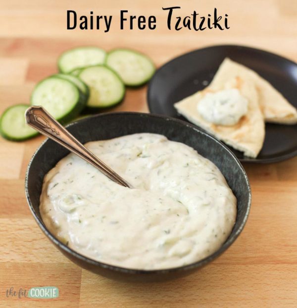 vegan tzatziki in a black bowl with a spoon