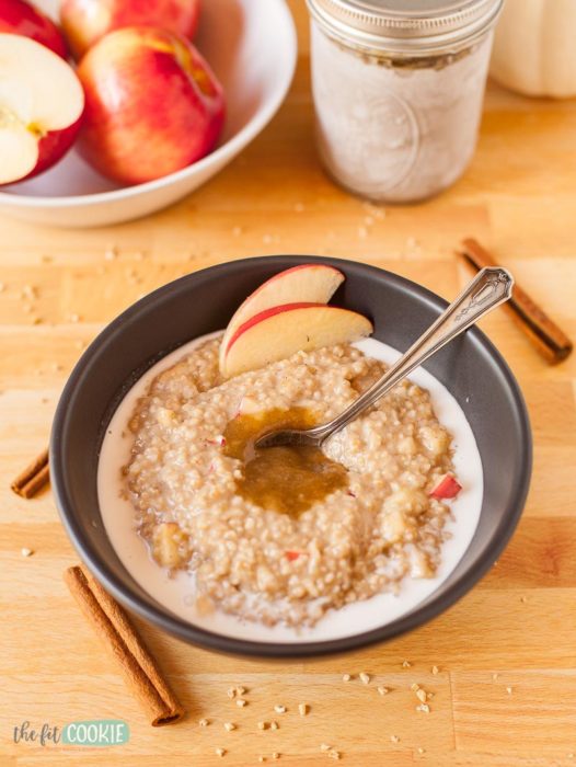 instant pot apple cinnamon oatmeal in a bowl with apples