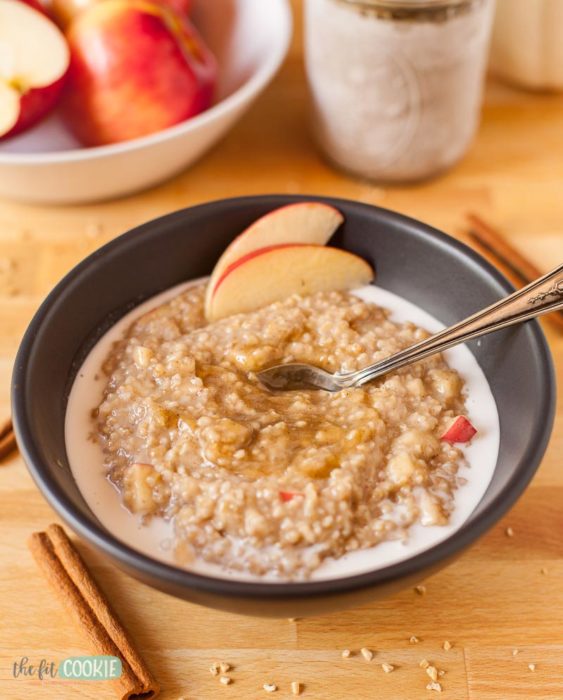 instant pot oatmeal in a black bowl with apples