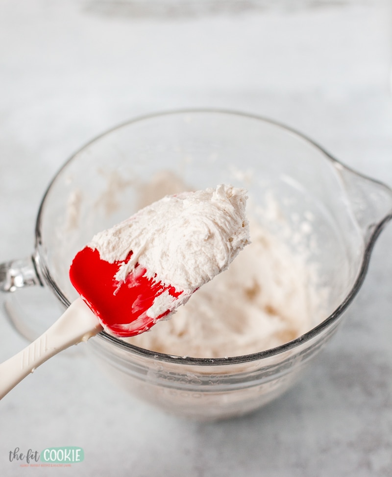 white vanilla frosting on a spoon