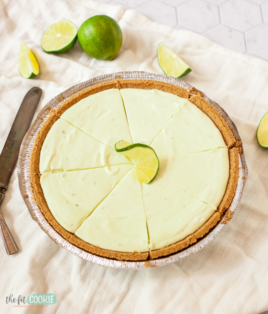 Sliced light green cheesecake in a gluten free crust