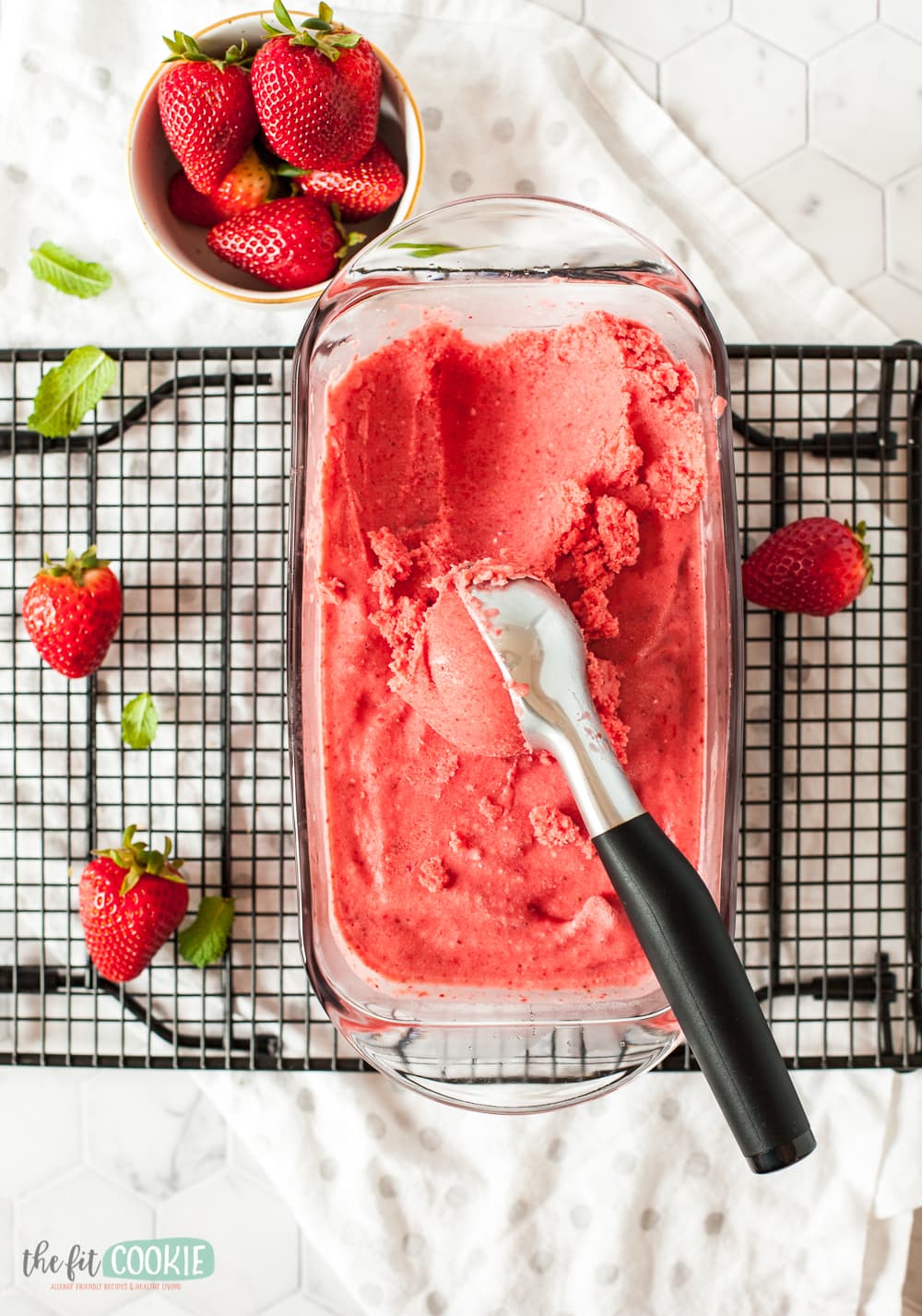 overhead photo of dairy free strawberry ice cream in a glass dish